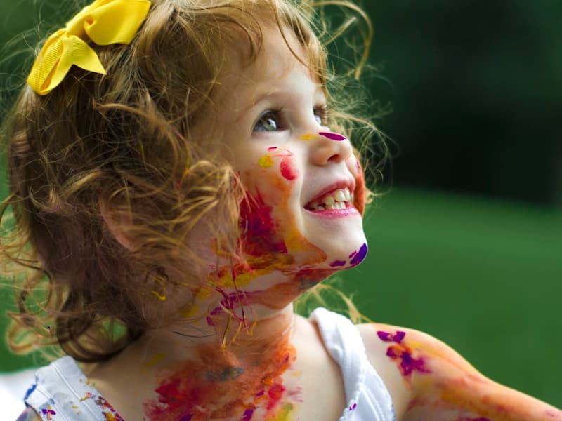 Young child playing with paint