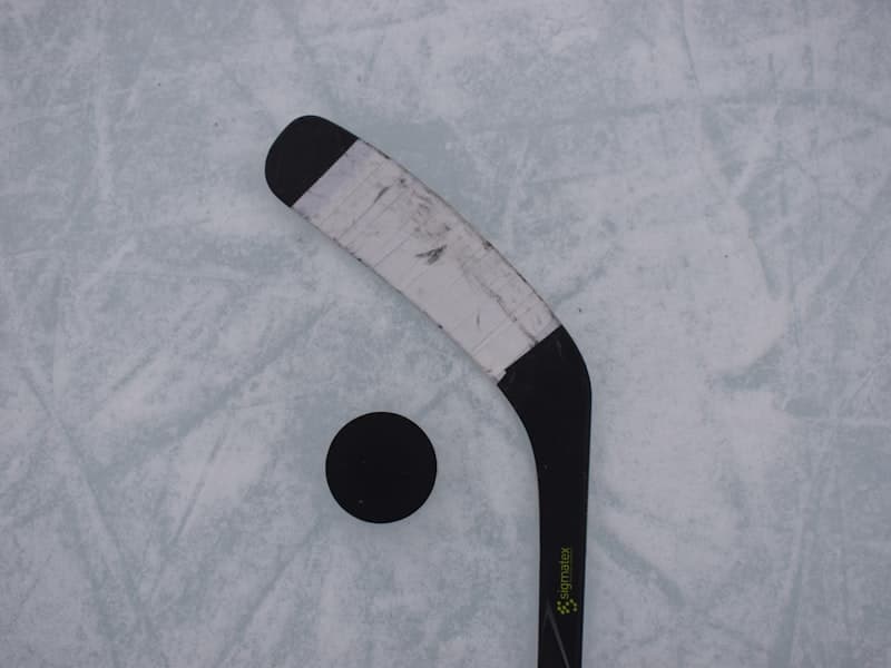 Hockey stick and puck on ice