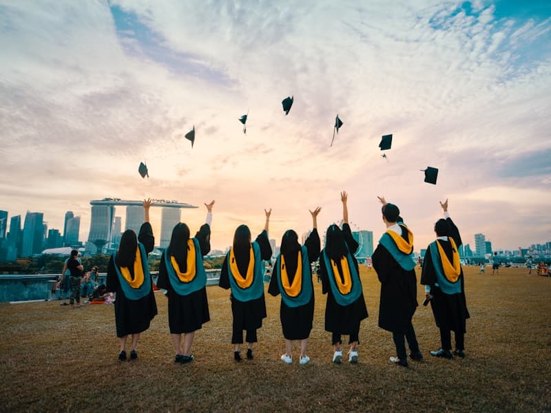 Graduation caps thrown in the air